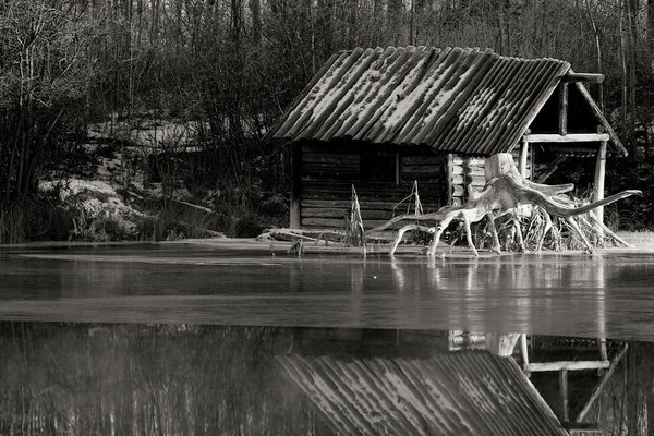 Black and white landscape of a house by the river