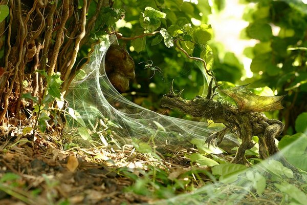 White cobwebs on green grass