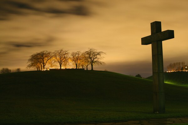 The cross and the trees in the sunset light