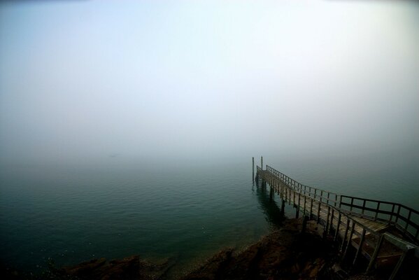 Foggy morning on a wooden pier