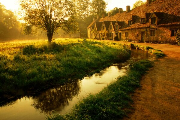 House in autumn near a pond at sunset