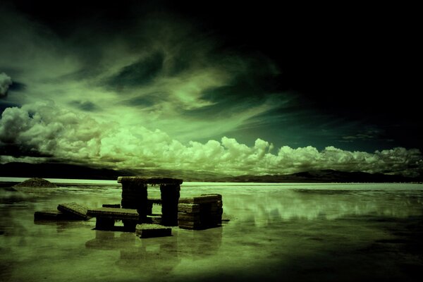 Stone slab in the lake on a night background