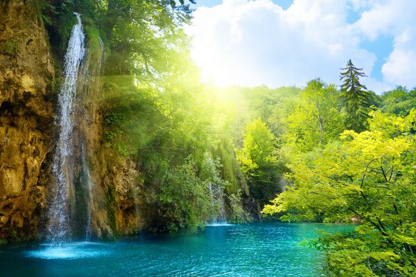 Mountain waterfall under the sun