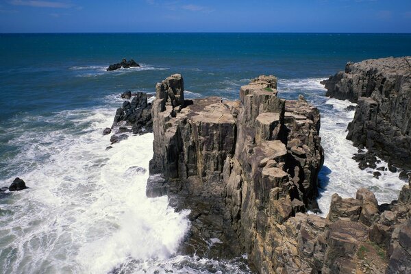 Clear sky. Rocks near the sea