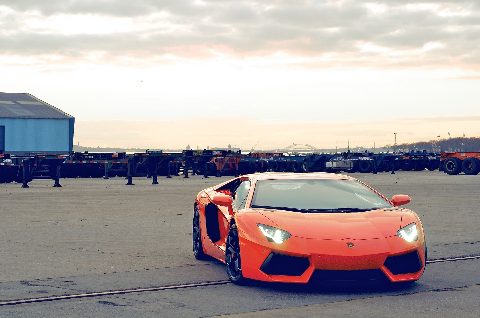 lamborghini aventador lp700-4 orange lamborghini aventador front view headlights sky clouds building