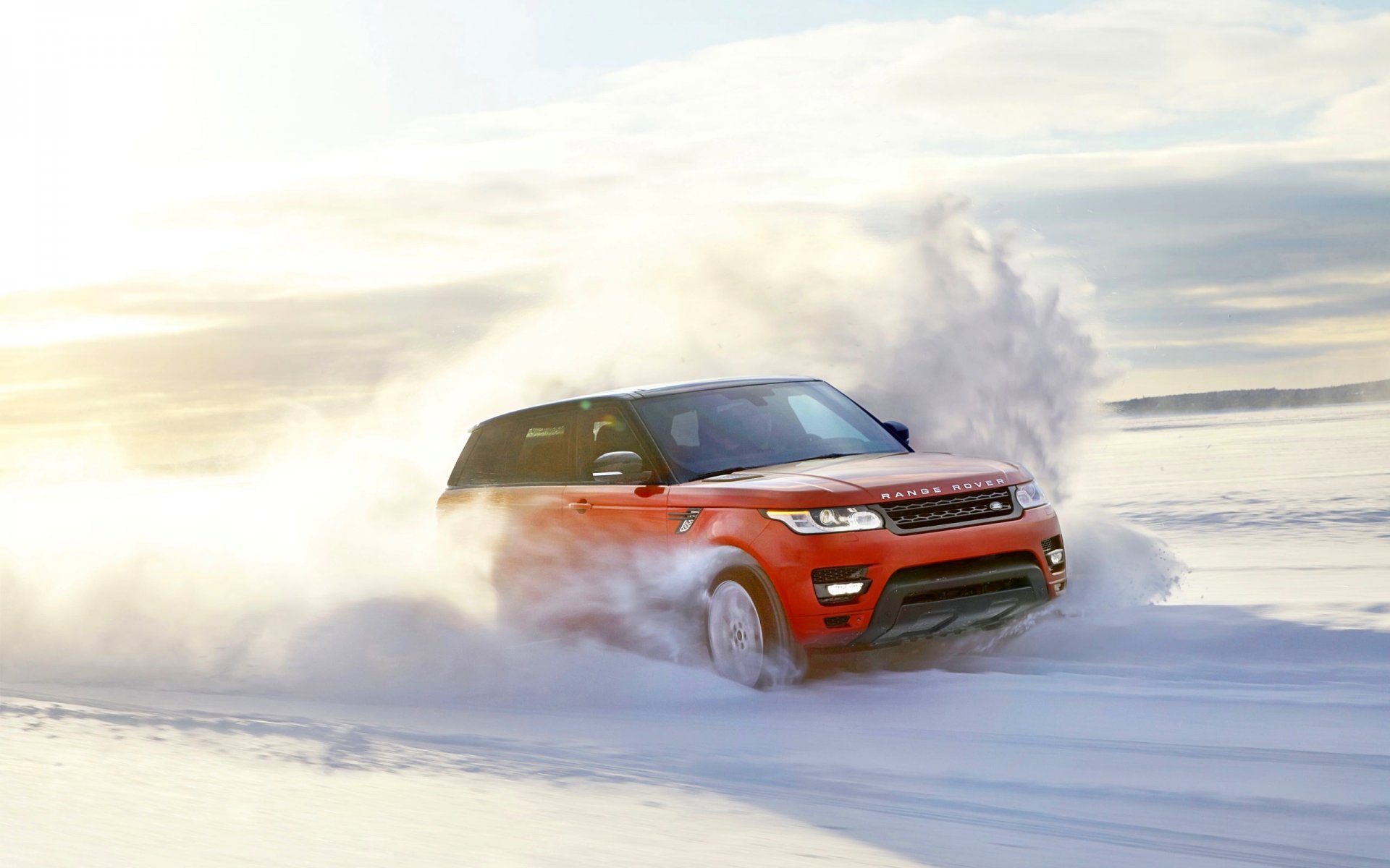 land rover range rover sport rouge neige hiver vitesse en mouvement jour soleil