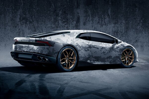 Super car of gray color. The car on the wallpaper. Gold discs