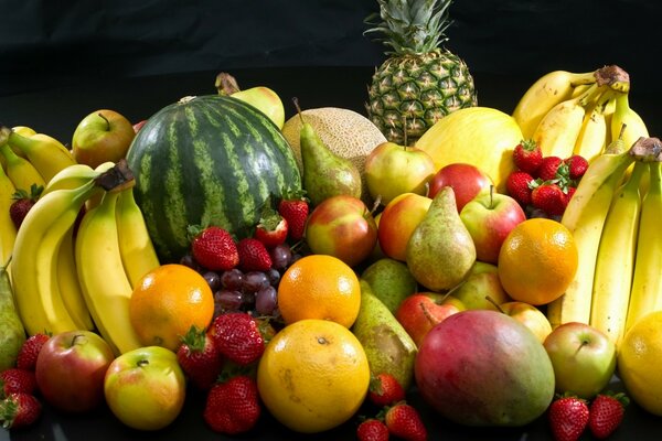 A large number of fruits lie and watermelon