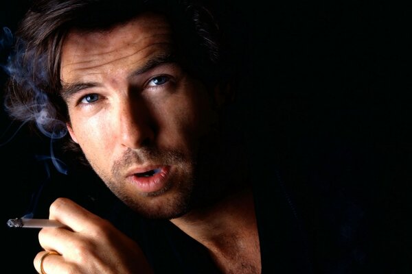 Actor Pierce Brosnan smokes