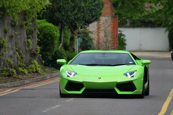 A Lamborghini of bright saturated color rides along the city road