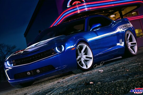 Blue Chevrolet Camaro on the background of the building