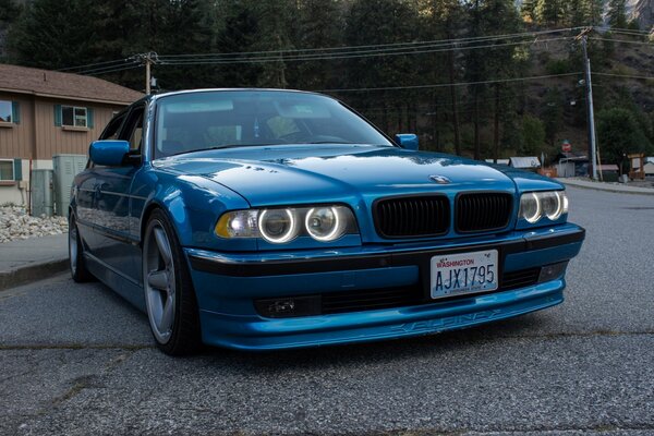 Blue BMW on the background of nature