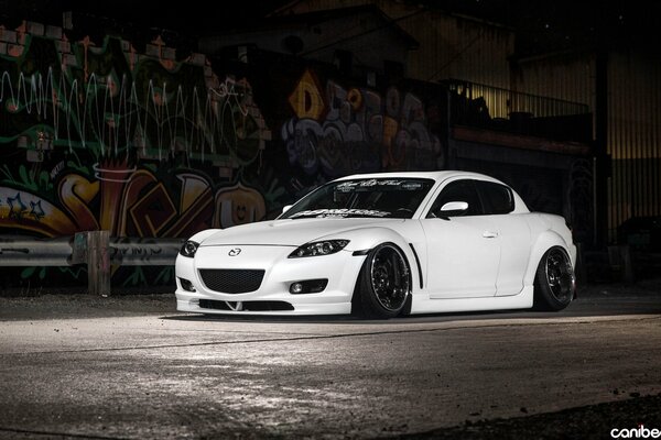 White Mazda Rx-8 at the painted wall