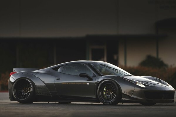 Black Ferrari in the parking lot in the evening