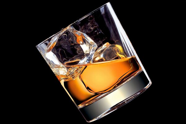 Whiskey with ice on a black background