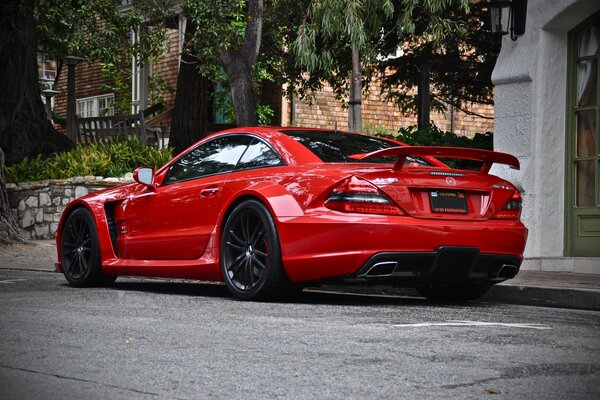 Rear view of a red Mercedes SL65 parked on the side of the road