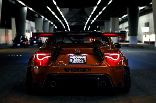 Rear view of a red car in a tunnel