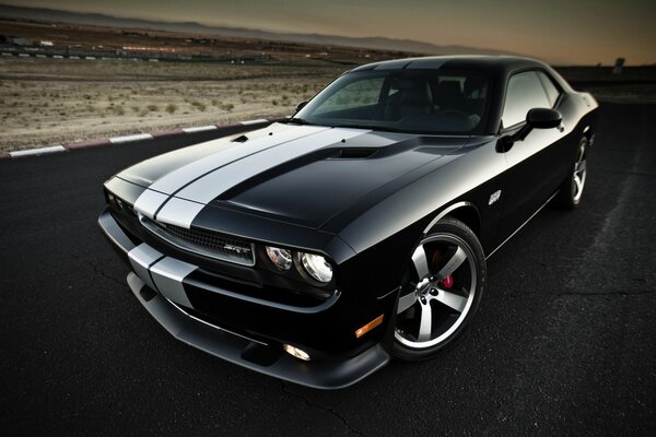 Dodge challenger on the background of a beautiful sunset