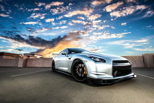 Silver nissan r35 on the background of a beautiful sunset