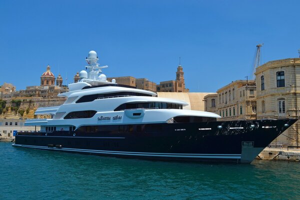 Yacht at the marina next to a beautiful building