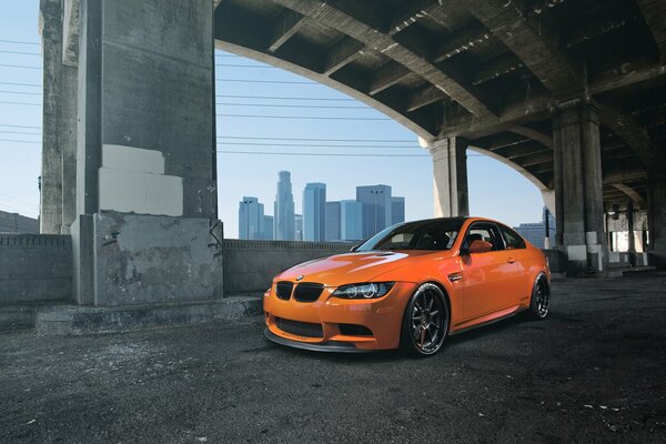 Orange BMW on the bridge front view