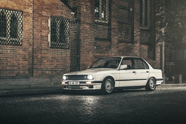 White BMW in the middle of the night city