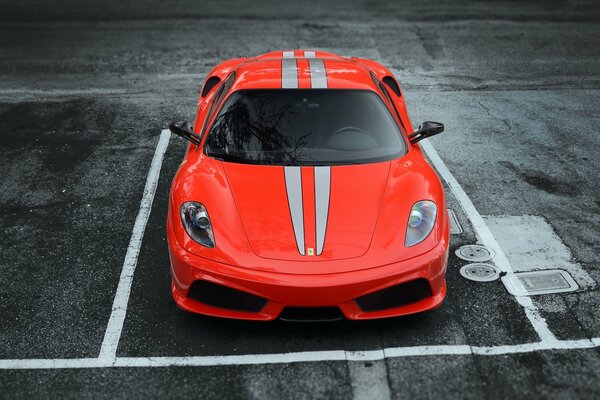 Red ferrari scuderia in the parking lot, front view