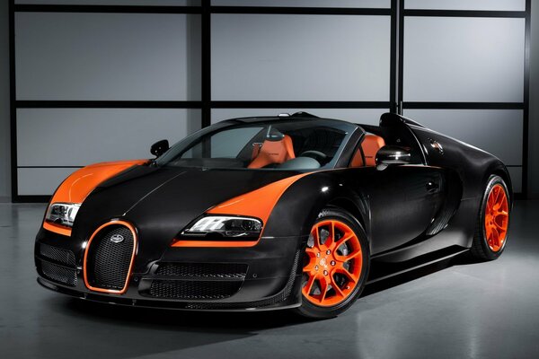 The Bugati veyron car is standing against the wall and the front is visible