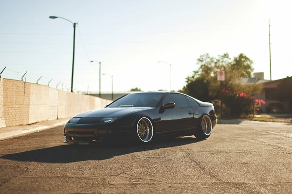 Black Nissan on a sunny road