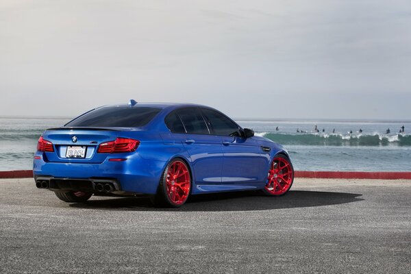 Rear blue bmw with red wheels