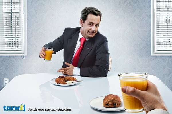 Two actors Nicolas Paul and Stephane Sarkozy at a table with glasses