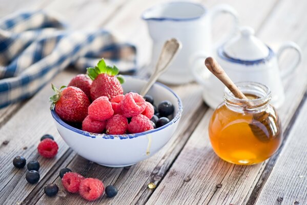 Fresas y frambuesas en un tazón sobre la mesa