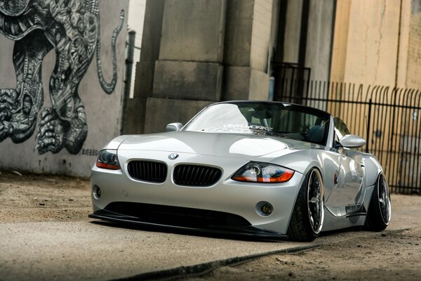 White tuned BMW with red headlights