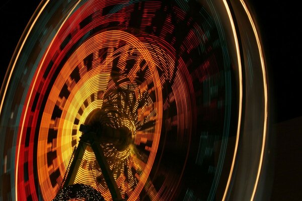 Ferris wheel photographed at night with a long exposure