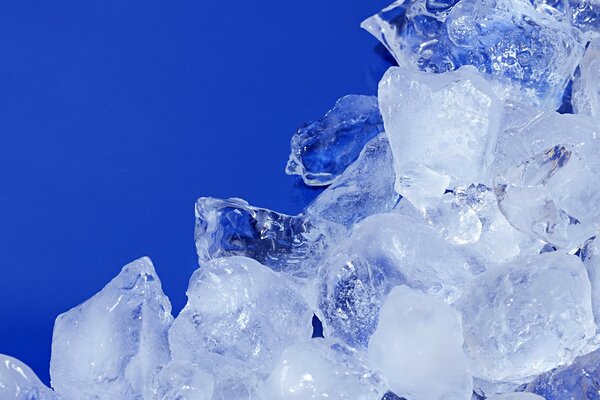 Pieces of ice lie on a blue background