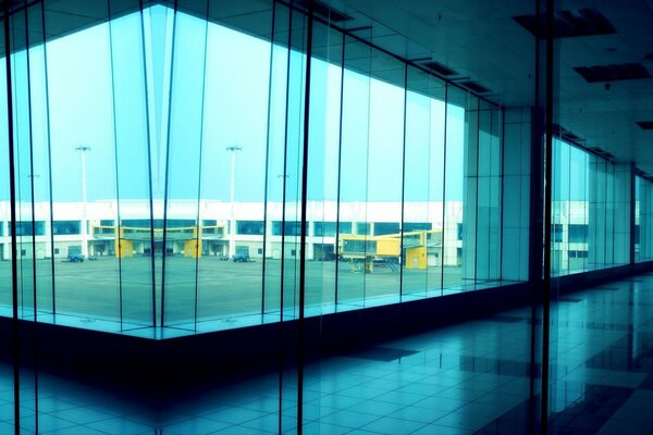 Panoramic photo of a building with large windows from the inside