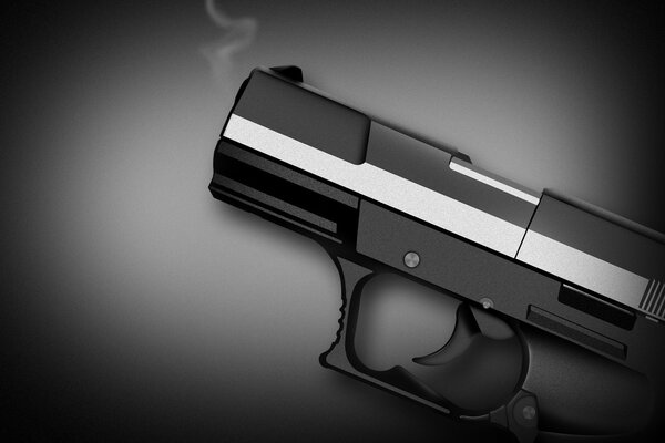 Pistolet noir sur une surface sombre