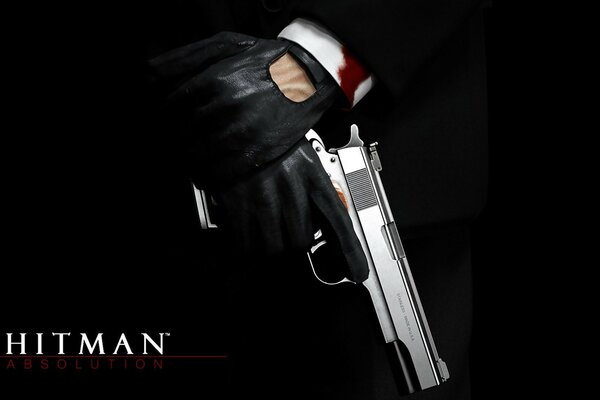 Logo gry Hitman i pistolet w ręku