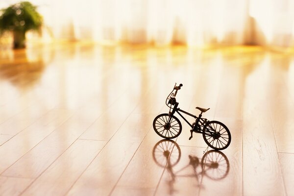 A small toy bicycle on a blurry background