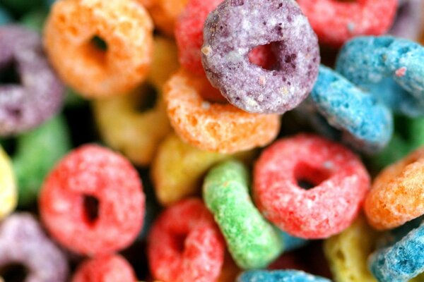 Multicolored bagels in icing sugar