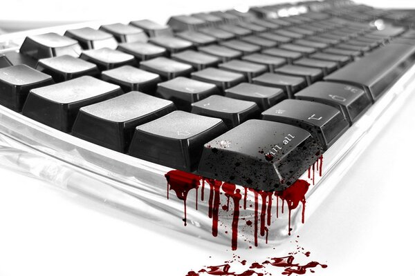 Streaks and drops of blood on the corner of the keyboard