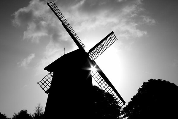 Black and white painting of a mill in the distance