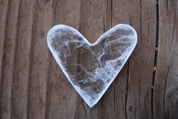 A heart made of ice on a wooden table