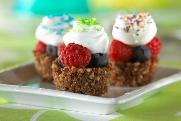 Pie with cream and berries on plates