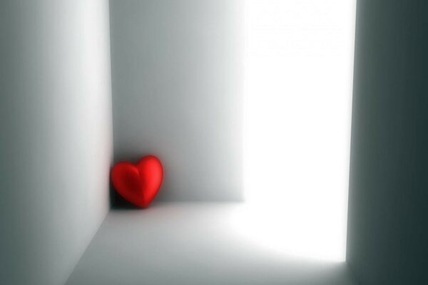 A lonely red heart in a corner is bored