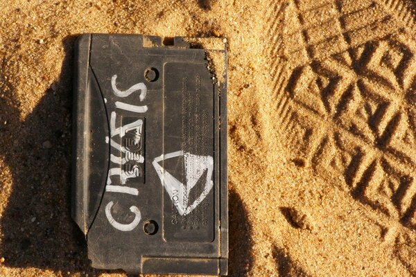 Déchets avec une inscription sur le sable avec une trace