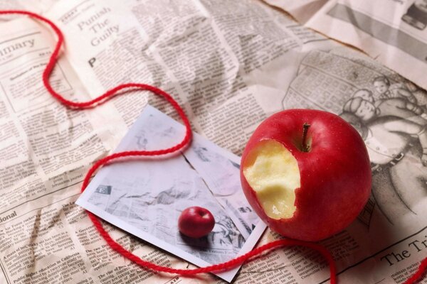 A crunchy apple on the background of a newspaper