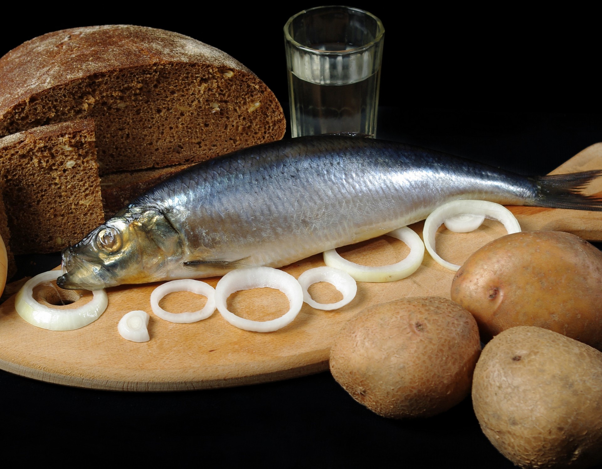 board vodka bulb rings potatoes glass black bread herring