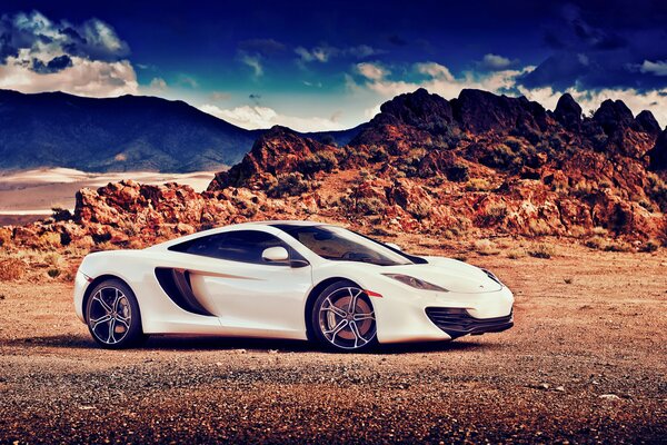 White McLaren stands in the mountains