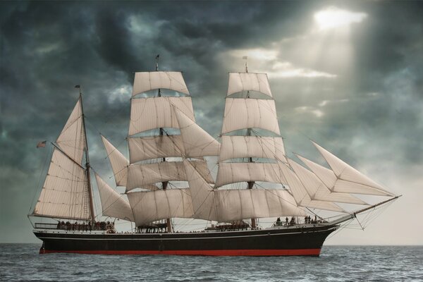 Sailing ship star of India in the sea against the background of clouds